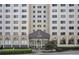 Exterior shot of the building entrance, with a modern glass facade and manicured landscaping at 2479 Peachtree Ne Rd # 1115, Atlanta, GA 30305