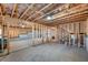 Spacious unfinished basement featuring exposed ceiling beams and framed walls ready for customization at 5345 Coltman Dr, Cumming, GA 30028