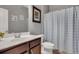 Bathroom featuring a single sink vanity and a shower with blue and white striped curtain at 5345 Coltman Dr, Cumming, GA 30028