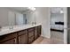 Bathroom features double sinks, dark cabinets, and a view into the bedroom at 5345 Coltman Dr, Cumming, GA 30028