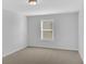 Neutral bedroom with plush carpet, a window for natural light and a ceiling light at 5345 Coltman Dr, Cumming, GA 30028