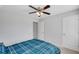 Bedroom with a ceiling fan, a closed closet door and bed with a blue plaid comforter at 5345 Coltman Dr, Cumming, GA 30028