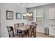 Dining room with a chandelier, a window, and a dark wood table with six chairs at 5345 Coltman Dr, Cumming, GA 30028