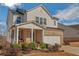 Charming two-story home featuring a brick and siding facade, covered porch, and attached two-car garage at 5345 Coltman Dr, Cumming, GA 30028