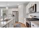 Bright kitchen with stainless steel appliances, granite countertops and white cabinetry at 5345 Coltman Dr, Cumming, GA 30028