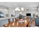 Kitchen flows to dining with a stainless steel fridge, granite counters, and dark wood table at 5345 Coltman Dr, Cumming, GA 30028