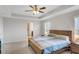 Spacious main bedroom featuring a tray ceiling, ceiling fan and ensuite bathroom at 5345 Coltman Dr, Cumming, GA 30028