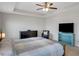 Spacious main bedroom featuring a tray ceiling, a ceiling fan and neutral colors at 5345 Coltman Dr, Cumming, GA 30028