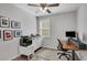 This modern office has a ceiling fan, a window and stylish decor at 5345 Coltman Dr, Cumming, GA 30028