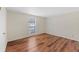 Large bedroom featuring a window for natural light, plus hardwood floors and light neutral walls at 601 Park Ridge Cir, Marietta, GA 30068