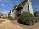 Condominium featuring private balconies with natural landscaping and lawn under cloudy blue sky at 601 Park Ridge Cir, Marietta, GA 30068