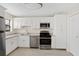 Well-lit kitchen with stainless steel appliances and stylish white cabinetry at 601 Park Ridge Cir, Marietta, GA 30068