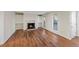 Bright living room featuring a fireplace, built-in shelving, and gleaming hardwood floors at 601 Park Ridge Cir, Marietta, GA 30068