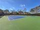 View of outdoor tennis courts on a sunny day with lots of surrounding greenery at 601 Park Ridge Cir, Marietta, GA 30068