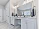 This bathroom featuring tile floors, a double vanity, ample storage, and updated light fixtures at 274 Fountain Oak Way, Canton, GA 30114