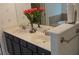 Bathroom featuring double sinks with granite counters, dark cabinets, and a large mirror at 3534 S Sherwood Se Rd, Smyrna, GA 30082