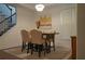 Formal dining room with seating for four, modern chandelier, and staircase at 3534 S Sherwood Se Rd, Smyrna, GA 30082