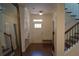 Bright foyer with wood floors, staircase, and a view of the front door at 3534 S Sherwood Se Rd, Smyrna, GA 30082