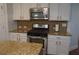 Kitchen featuring stainless steel oven and microwave, granite counters, and white cabinetry at 3534 S Sherwood Se Rd, Smyrna, GA 30082