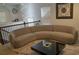 Bright living room with a unique curved couch, complemented by a stylish black coffee table, decorative art, and ample natural light at 3534 S Sherwood Se Rd, Smyrna, GA 30082