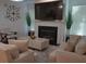 Bright living room features a fireplace, modern furniture, and a large window at 3534 S Sherwood Se Rd, Smyrna, GA 30082