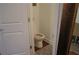 Cozy powder room featuring hardwood floors, a toilet, and a patterned rug at 3534 S Sherwood Se Rd, Smyrna, GA 30082