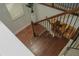 Hardwood staircase with decorative railing, leading to the lower level at 3534 S Sherwood Se Rd, Smyrna, GA 30082