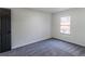 Cozy bedroom featuring neutral tones, gray carpet, and a window with natural light at 157 Pebble Path, Douglasville, GA 30134