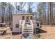 Charming home exterior featuring a deck, backyard, and inviting entrance, all surrounded by a beautiful wooded area at 157 Pebble Path, Douglasville, GA 30134