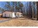 Charming home with a welcoming front porch surrounded by a wooded landscape at 157 Pebble Path, Douglasville, GA 30134