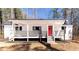 Charming single-story home boasts a covered porch and bright red front door at 157 Pebble Path, Douglasville, GA 30134
