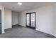 Inviting room with plush carpet, neutral tones, and a double-door entrance at 157 Pebble Path, Douglasville, GA 30134