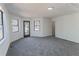 Spacious room with multiple windows, plush gray carpet, and natural light at 157 Pebble Path, Douglasville, GA 30134