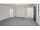 Large room featuring neutral walls, carpet, and natural light from multiple windows at 157 Pebble Path, Douglasville, GA 30134