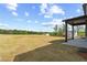 Expansive backyard with a view of lush greenery and a covered patio, perfect for outdoor activities at 7685 Homer Dr, Cumming, GA 30028