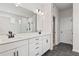 Stylish bathroom equipped with double vanities, modern fixtures, and a separate shower with glass doors at 7685 Homer Dr, Cumming, GA 30028