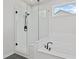 Modern bathroom featuring a glass-enclosed shower and a luxurious soaking tub with black fixtures at 7685 Homer Dr, Cumming, GA 30028