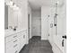 Modern bathroom equipped with double vanities, modern fixtures, and a separate shower with glass doors at 7685 Homer Dr, Cumming, GA 30028