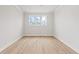Bright and airy bedroom with hardwood floors and multiple windows offering ample natural light at 7685 Homer Dr, Cumming, GA 30028
