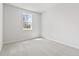 Bright and simple bedroom design with a neutral color palette and a large window at 7685 Homer Dr, Cumming, GA 30028