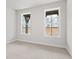 Cozy bedroom with carpeted floors, neutral walls, and large windows offering pleasant views at 7685 Homer Dr, Cumming, GA 30028