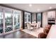 Bright dining room with dark wood floors, a table with seating for six, and sliding glass doors to the outdoor patio at 7685 Homer Dr, Cumming, GA 30028
