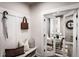Welcoming entryway with bench and coat rack, leading to a bright office with french doors at 7685 Homer Dr, Cumming, GA 30028