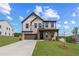Charming two-story home featuring a brick and siding facade, a two-car garage, and a well-manicured lawn at 7685 Homer Dr, Cumming, GA 30028