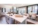 Open concept kitchen with a center island, stainless steel appliances, and views of the breakfast nook and living room at 7685 Homer Dr, Cumming, GA 30028