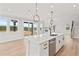 Bright kitchen featuring a large center island, stainless steel appliances, and an open layout with sliding glass doors at 7685 Homer Dr, Cumming, GA 30028
