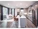 Modern kitchen with a center island, stainless steel appliances, and a breakfast nook with seating for six at 7685 Homer Dr, Cumming, GA 30028