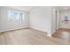 Bright living room featuring hardwood floors, neutral walls, and ample natural light from large windows at 7685 Homer Dr, Cumming, GA 30028