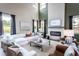 Modern living room with a white brick fireplace at 7685 Homer Dr, Cumming, GA 30028