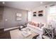 Bright living room with shiplap accent wall, comfortable seating, and stylish decor at 7685 Homer Dr, Cumming, GA 30028
